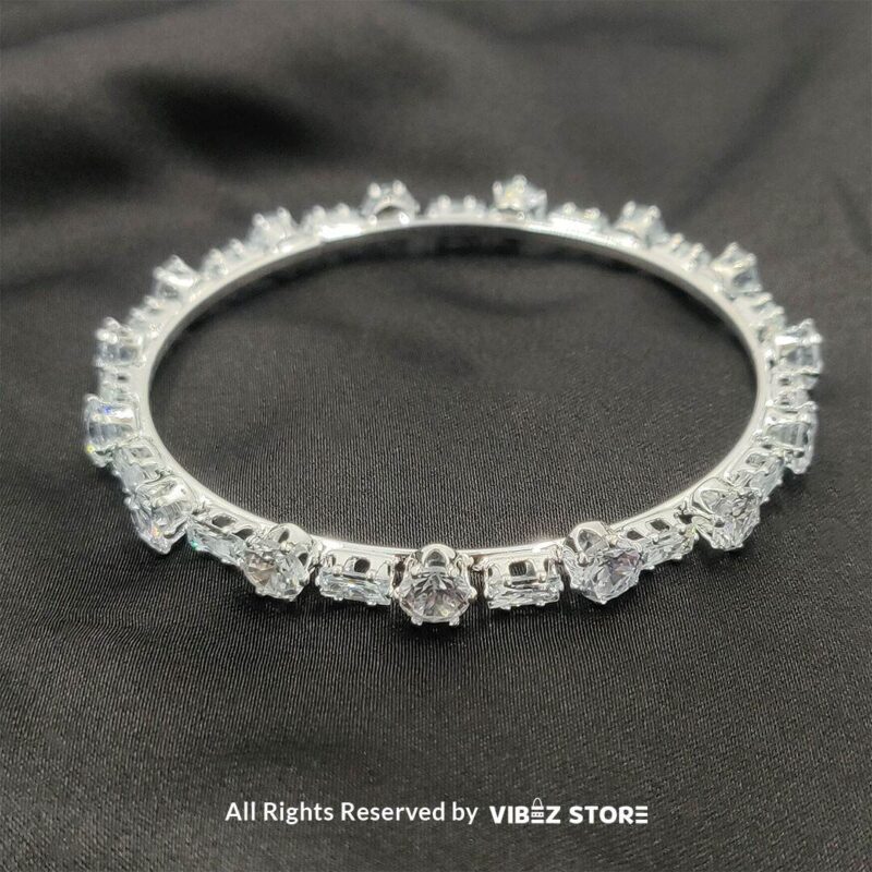 Sparkling Silver-Toned Crystal Bangle Set 2 Silver-toned crystal bangle set with intricate detailing on a black background
