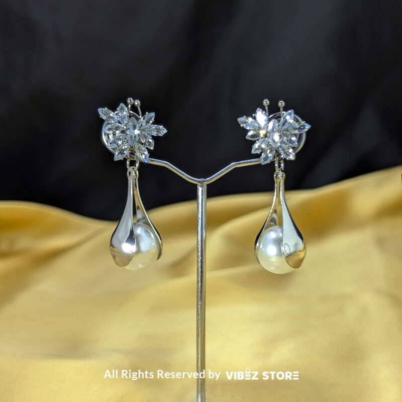 Sparkling Floral Pearl Drop Earrings 2 Crystal floral earrings with teardrop pearl accents, displayed in gold and silver variations by Vibez Store.