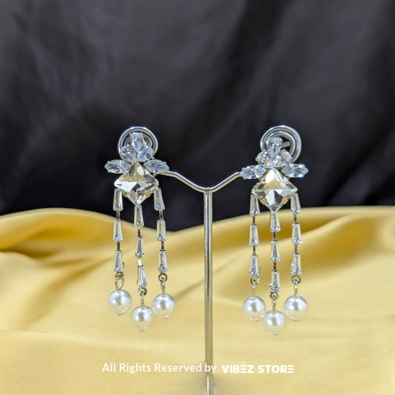 Elegant Crystal and Pearl Dangle Earrings 1 Crystal dangle earrings with floral embellishments and pearl drops, displayed elegantly by Vibez Store.