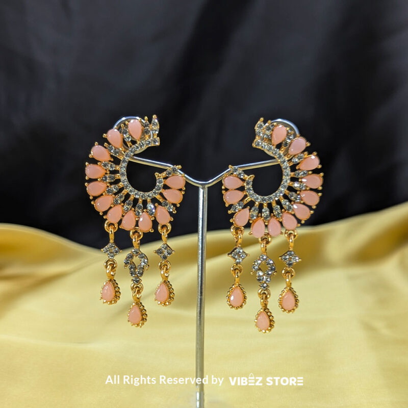 Elegant Teardrop Dangle Earrings 2 Teardrop dangle earrings in crescent design with crystal details, shown in pink and black color variations by Vibez Store.