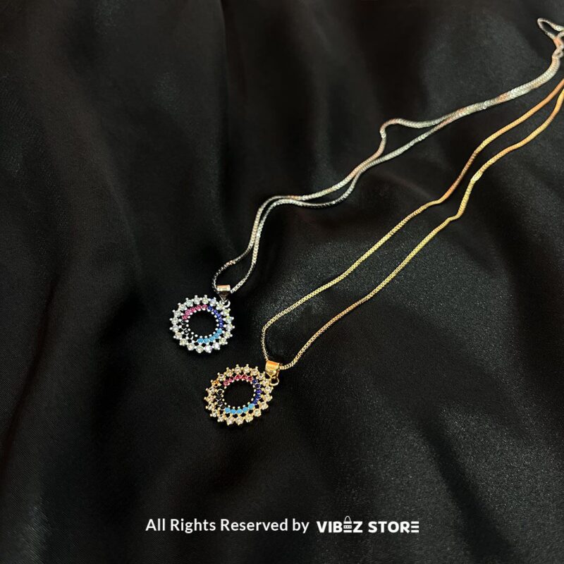 Circular Multicolor Crystal Locket 1 Circular Multicolor Crystal Locket with silver and gold-tone options on a black background