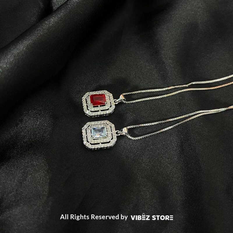 Square Gemstone Locket with Silver Accent 1 Square Gemstone Locket in ruby red and clear crystal with silver accents on a black background