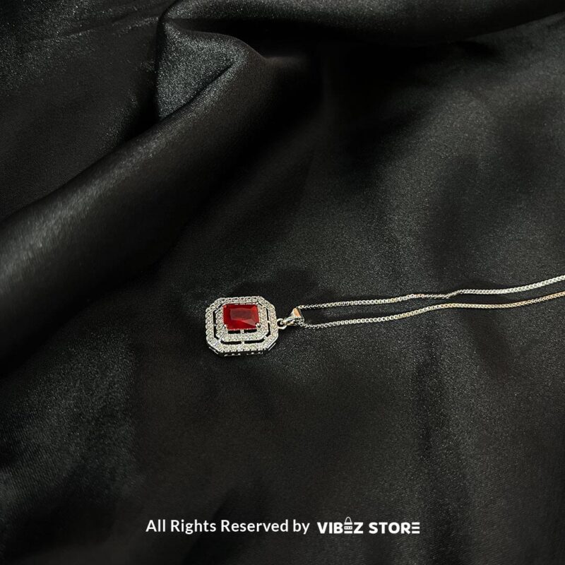 Square Gemstone Locket with Silver Accent 3 Square Gemstone Locket in ruby red and clear crystal with silver accents on a black background