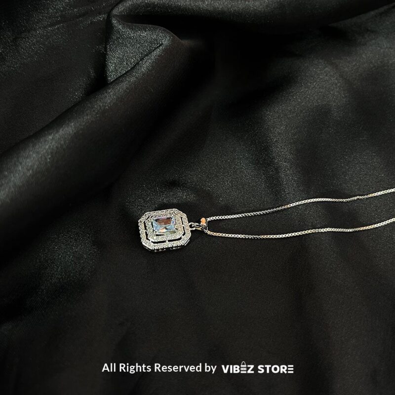 Square Gemstone Locket with Silver Accent 2 Square Gemstone Locket in ruby red and clear crystal with silver accents on a black background