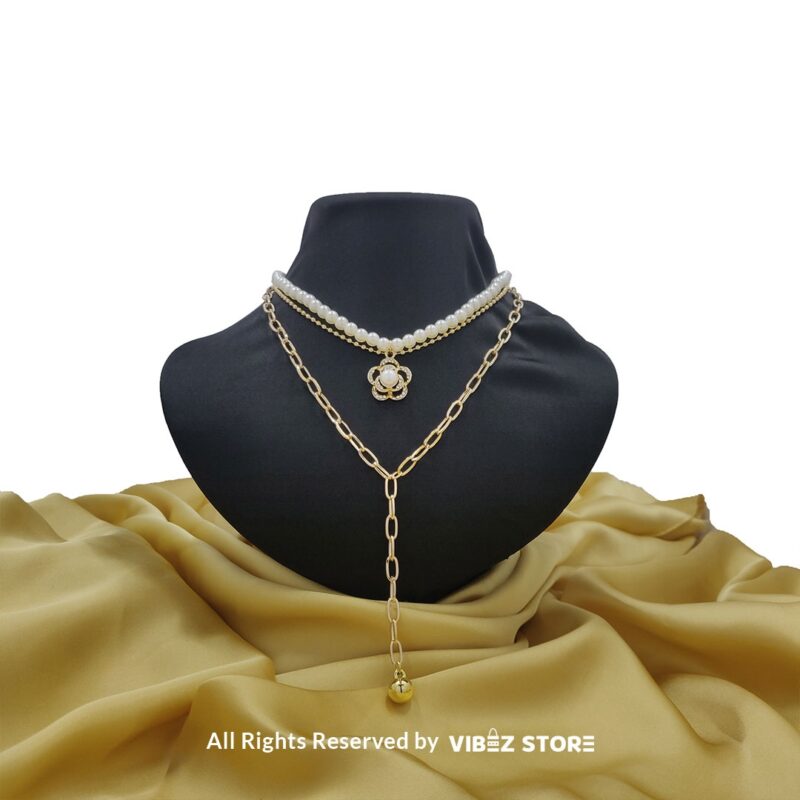 Pearl and Chain Layered Necklace with Flower Pendant 4 Pearl and gold chain layered necklace with flower pendant displayed on black bust