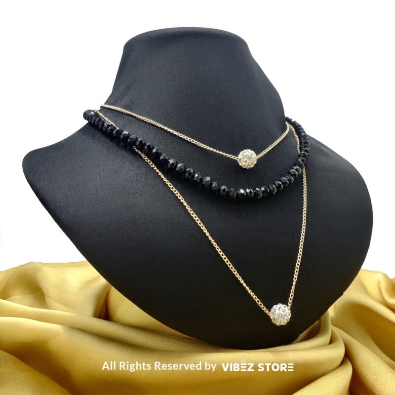 Triple-Layer Beaded and Chain Necklace with Crystal Ball Accent 2 Triple-layer necklace with black beads, gold chains, and crystal ball accent displayed on black bust