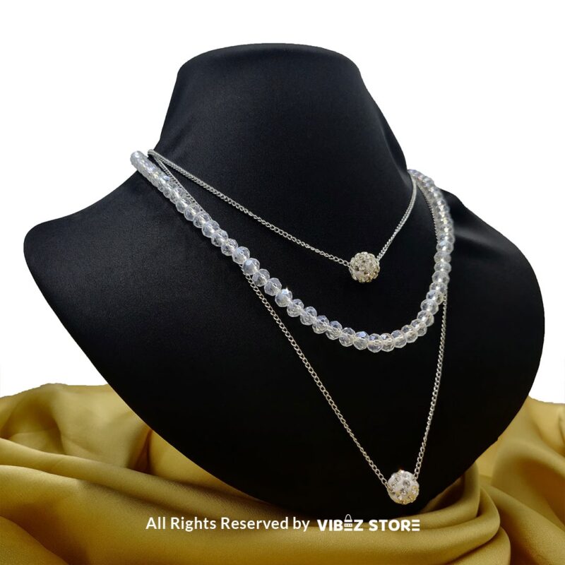 Triple-Layer Beaded and Chain Necklace with Crystal Ball Accent 5 Triple-layer necklace with black beads, gold chains, and crystal ball accent displayed on black bust