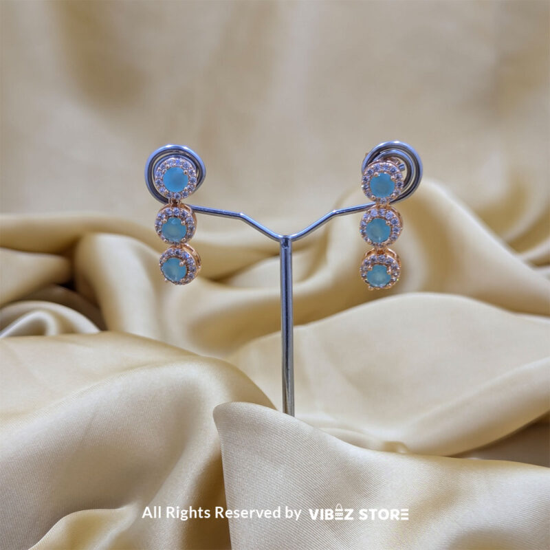 Elegant Aqua Blue Gemstone Jewelry Set 5 Gold-tone jewelry set with aqua blue gemstones, including a necklace, earrings, bracelet, and ring, elegantly displayed by Vibez Store.
