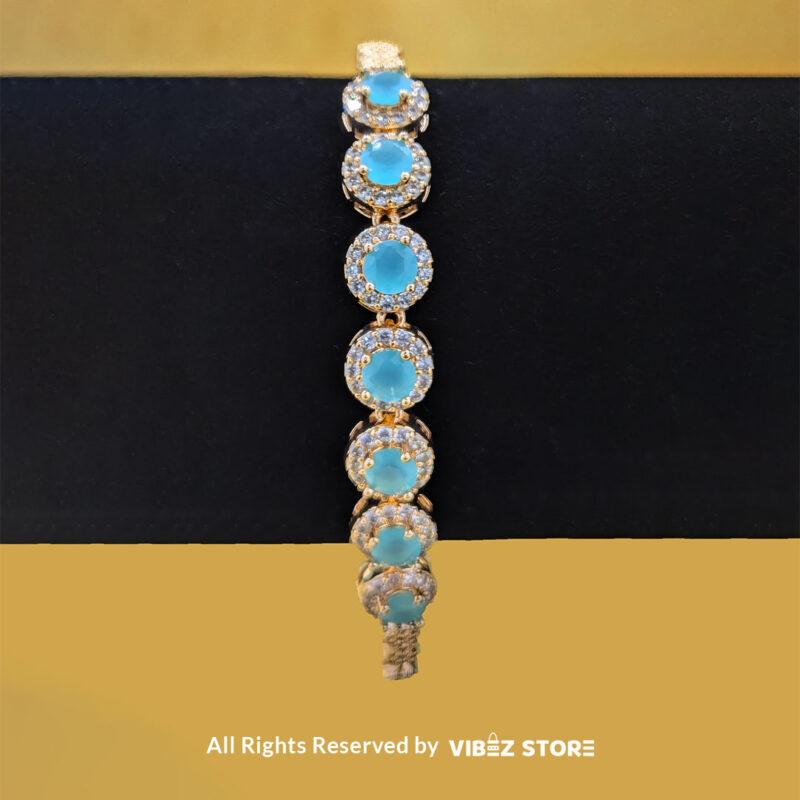 Elegant Aqua Blue Gemstone Jewelry Set 4 Gold-tone jewelry set with aqua blue gemstones, including a necklace, earrings, bracelet, and ring, elegantly displayed by Vibez Store.