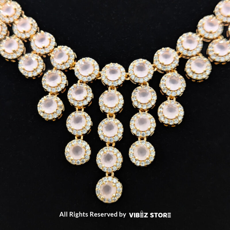 Elegant Rose Quartz Jewelry Set 1 Gold-tone jewelry set with rose quartz-inspired stones, including a necklace, earrings, bracelet, and ring, elegantly displayed by Vibez Store.