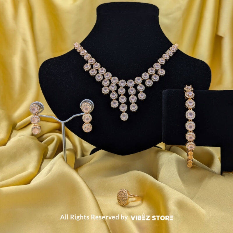 Elegant Rose Quartz Jewelry Set 3 Gold-tone jewelry set with rose quartz-inspired stones, including a necklace, earrings, bracelet, and ring, elegantly displayed by Vibez Store.