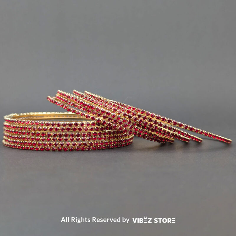 Elegant Red and Gold Stacked Bangle Set 1 Red and gold bangle set with intricate stone details, displayed elegantly by Vibez Store.