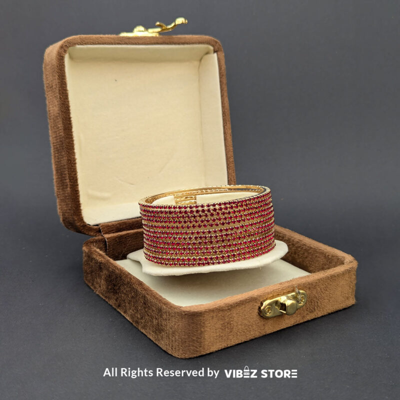 Elegant Red and Gold Stacked Bangle Set 2 Red and gold bangle set with intricate stone details, displayed elegantly by Vibez Store.