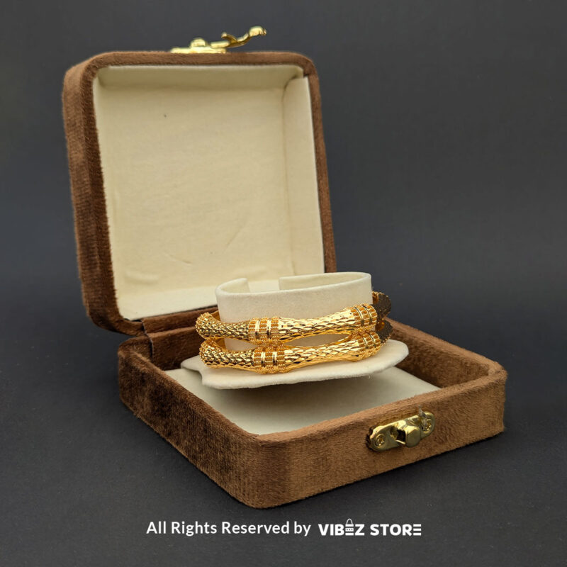 Textured Gold-Tone Twisted Bangle Pair 2 Pair of gold-tone twisted bangles with a textured finish, displayed elegantly by Vibez Store.