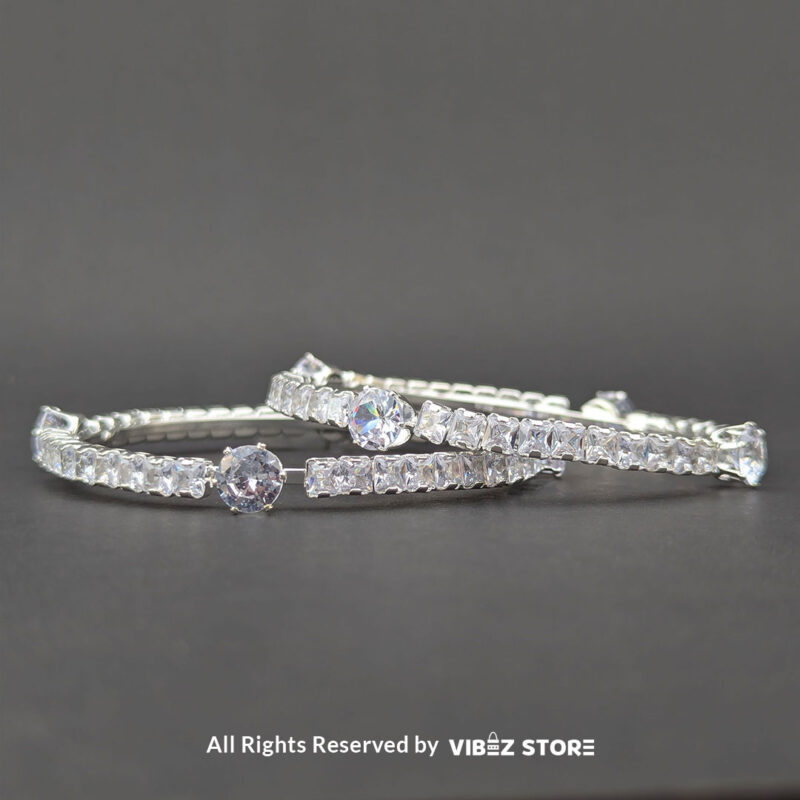 Elegant Silver Crystal Bangles 1 Elegant silver bangles with sparkling round and square-cut crystals on a sleek design.