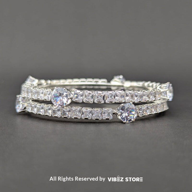Elegant Silver Crystal Bangles 2 Elegant silver bangles with sparkling round and square-cut crystals on a sleek design.