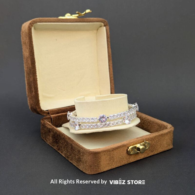 Elegant Silver Crystal Bangles 3 Elegant silver bangles with sparkling round and square-cut crystals on a sleek design.
