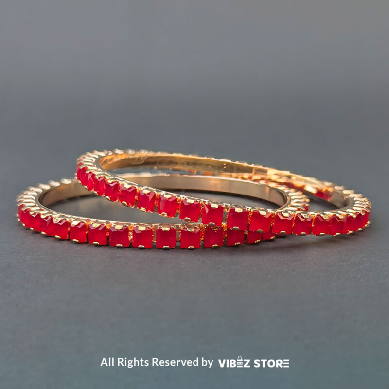 Red Crystal Rose Gold Bangles Set 1 Rose gold bangles set with vibrant red crystals for festive and party wear.