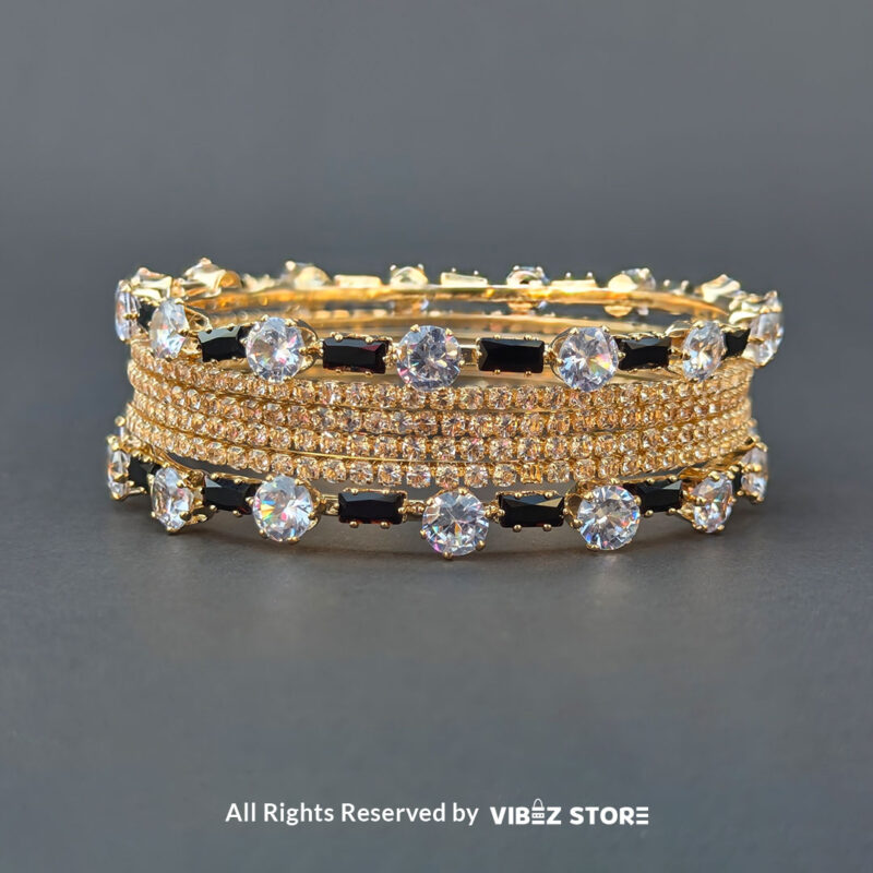 Black & White Crystal Gold Bangles Set 1 Gold bangles set with black stones and white crystals for festive and wedding wear.
