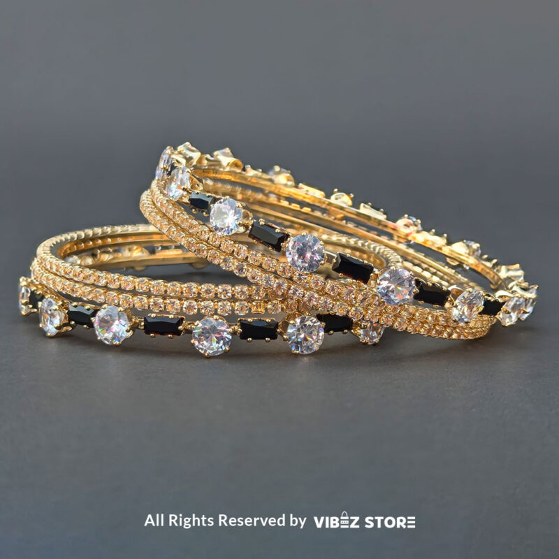 Black & White Crystal Gold Bangles Set 4 Gold bangles set with black stones and white crystals for festive and wedding wear.