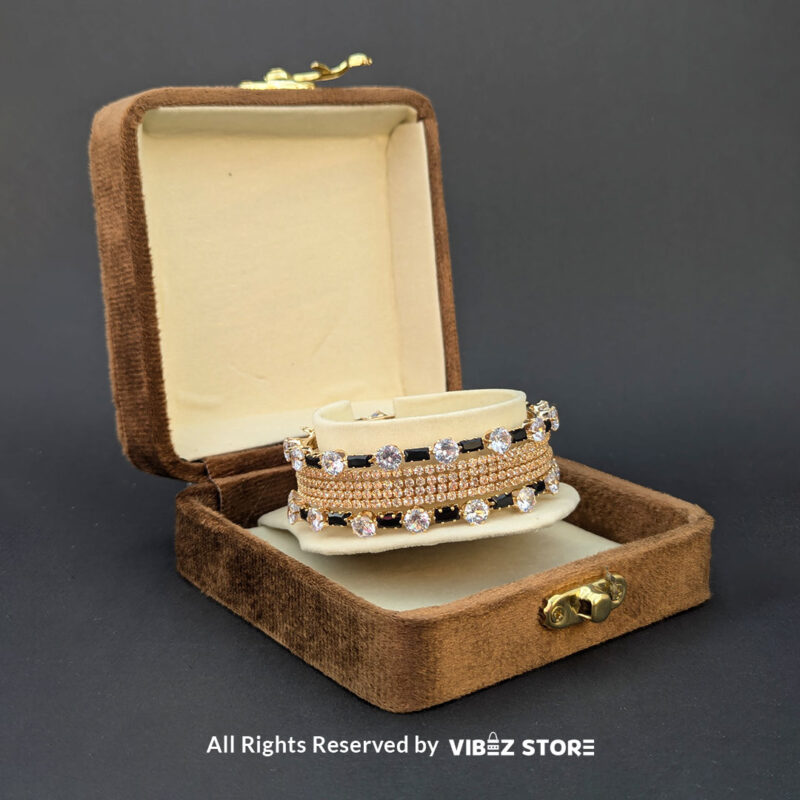 Black & White Crystal Gold Bangles Set 2 Gold bangles set with black stones and white crystals for festive and wedding wear.
