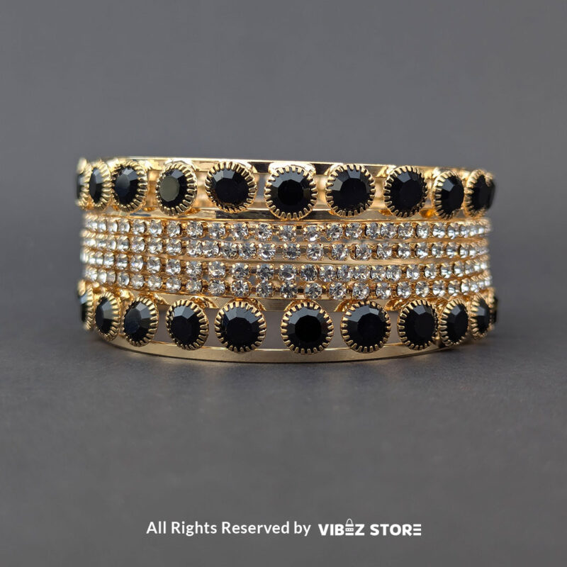 Gold-Plated Black Stone and Crystal Bangle Set 3 Gold-plated bangle set with black stones and crystal embellishments on a black background