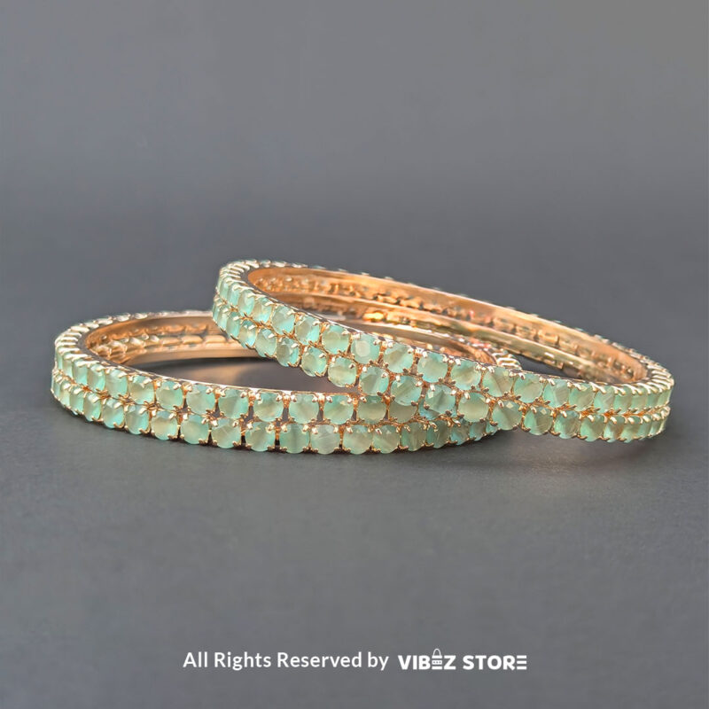 Sea Green Crystal Bangles Set 1 Sea green crystal bangles set on gold-tone base for festive wear.