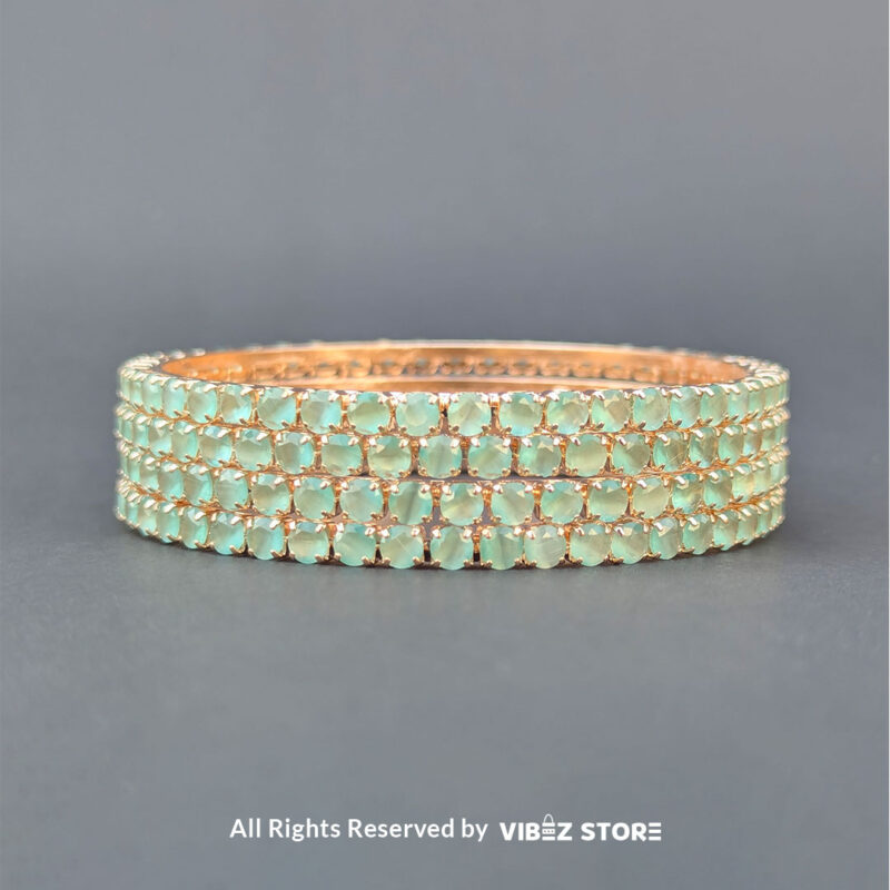Sea Green Crystal Bangles Set 2 Sea green crystal bangles set on gold-tone base for festive wear.