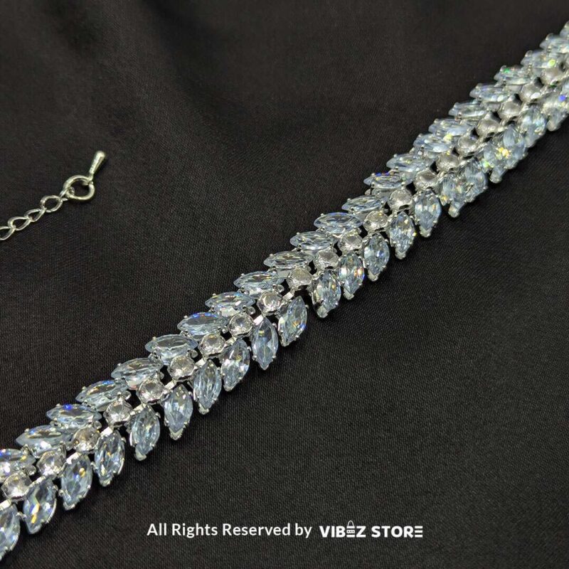 Silver-Tone Crystal Double Row Bracelet 1 Silver-tone double row crystal bracelet with shimmering marquise-cut stones on a black fabric background.