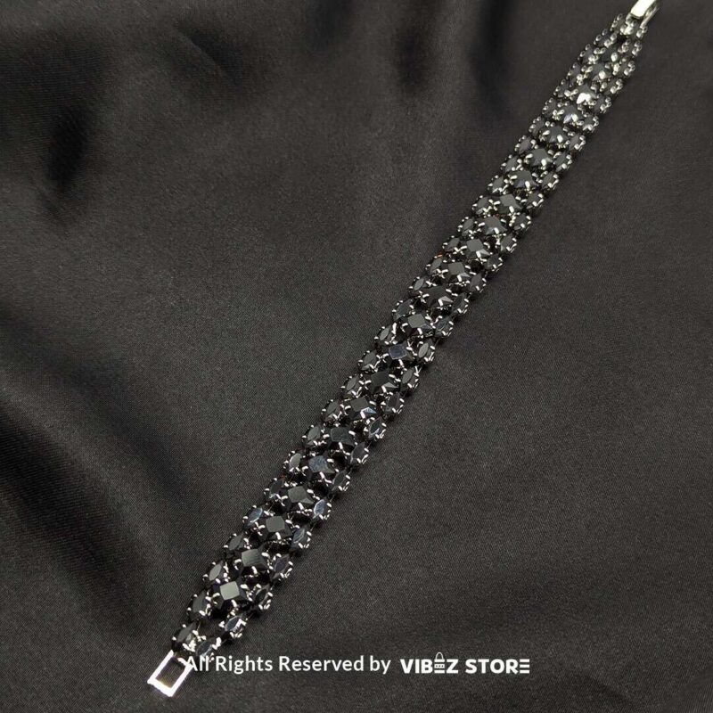 Black Stone Multi-Row Bracelet 1 Black stone multi-row bracelet with a silver-tone frame on a black fabric background.