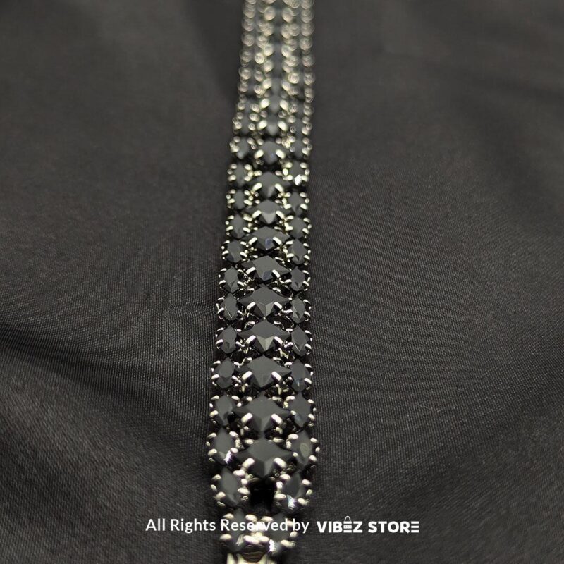 Black Stone Multi-Row Bracelet 3 Black stone multi-row bracelet with a silver-tone frame on a black fabric background.