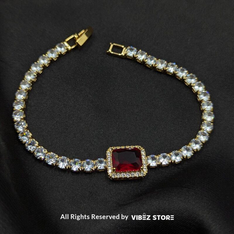 Crystal-Studded Gold Bracelets with Square Gemstone Centerpiece 2 Two crystal-studded gold bracelets with square gemstone centerpieces in ruby red and soft pink on a black fabric background.