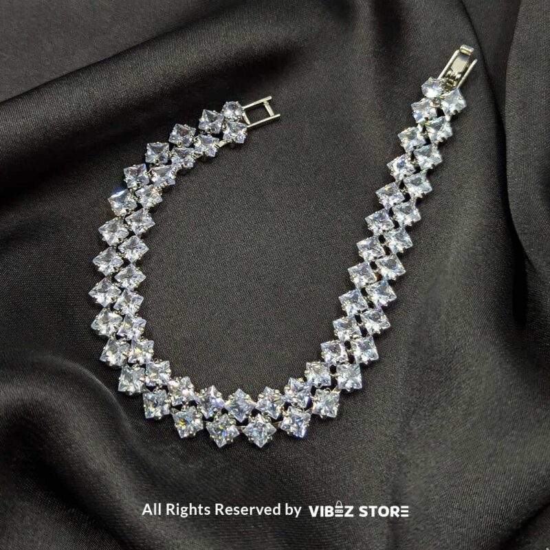 Luxury Diamond-Cut Crystal Bracelet 1 A luxury double-layered silver-tone bracelet with diamond-cut sparkling crystals displayed on a black fabric background.
