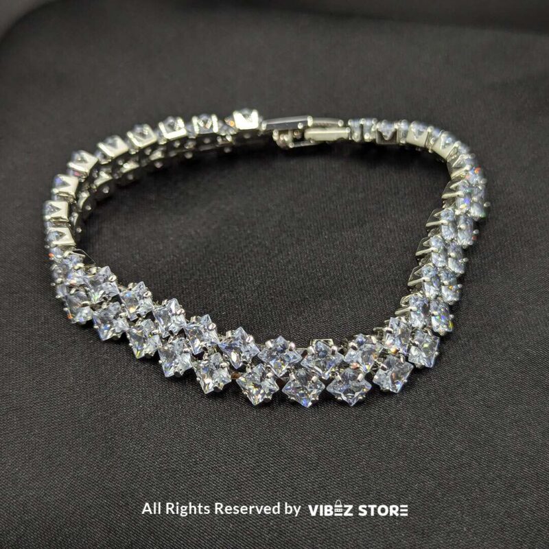 Luxury Diamond-Cut Crystal Bracelet 2 A luxury double-layered silver-tone bracelet with diamond-cut sparkling crystals displayed on a black fabric background.