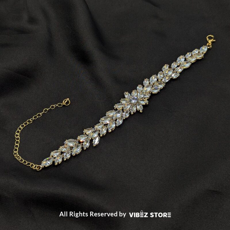 Crystal Floral Gold-Tone Bracelet 4 Gold-tone crystal floral bracelet with sparkling accents on black background.