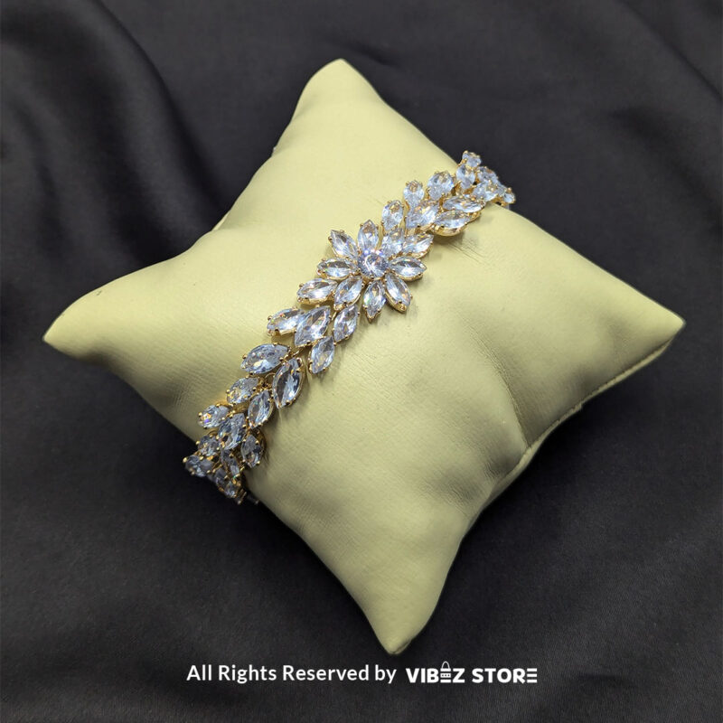 Crystal Floral Gold-Tone Bracelet 3 Gold-tone crystal floral bracelet with sparkling accents on black background.