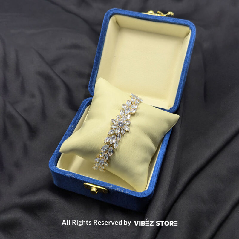 Crystal Floral Gold-Tone Bracelet 2 Gold-tone crystal floral bracelet with sparkling accents on black background.