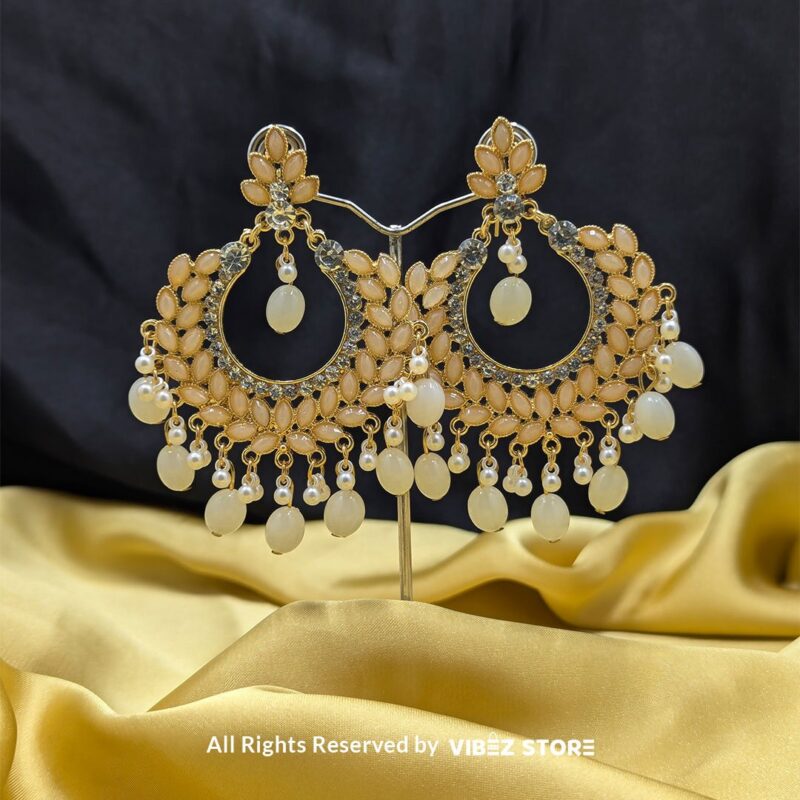 Pearl Drop Earrings 1 Close-up view of elegant Pearl Drop Earrings with golden detailing and dangling pearl accents.