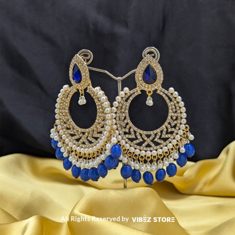 Blue Pearl Hoop Earrings 1 Close-up of Blue Pearl Hoop Earrings with intricate golden detailing and dangling blue pearls.