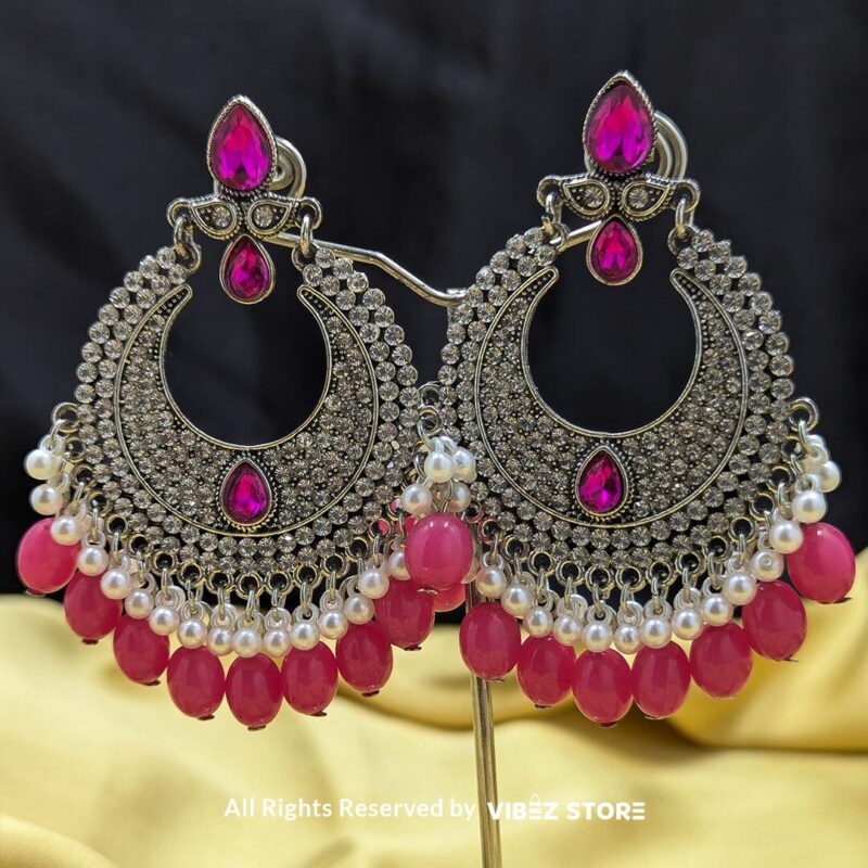 Pink Ethnic Statement Earrings with Crystal and Pearl Detailing 1 Pink ethnic statement earrings featuring intricate crystal work, vibrant pink stones, and dangling pearl accents, perfect for festive and traditional occasions.