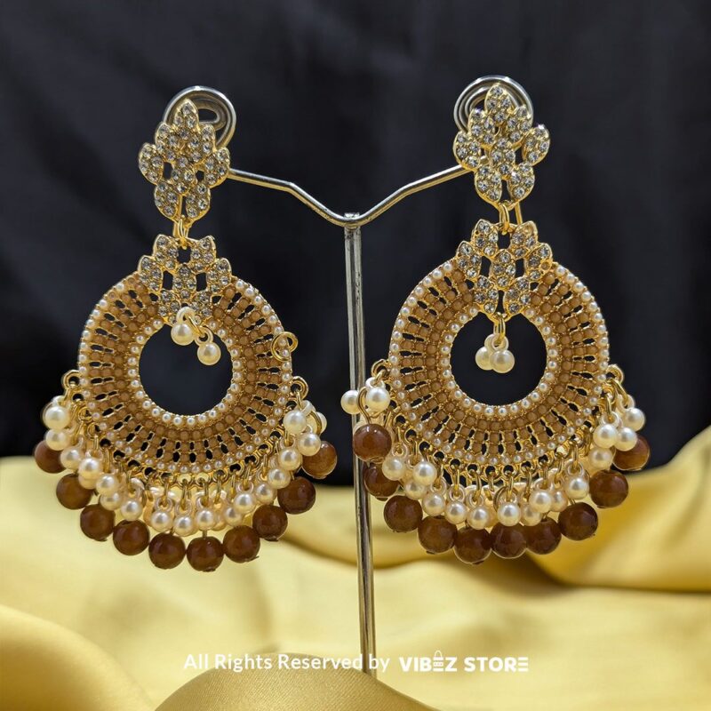 Golden Ethnic Pearl Earrings with Crystal and Bead Detailing 1 Golden ethnic statement earrings with intricate crystal detailing, pearls, and golden beads, perfect for weddings and traditional celebrations.