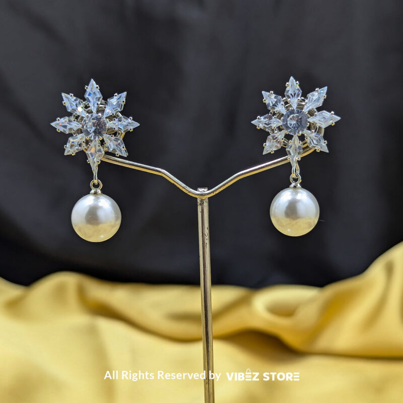 Snowflake Pearl Drop Earrings 1 Snowflake-inspired earrings with a pearl drop, featuring sparkling crystals, ideal for festive and formal wear.