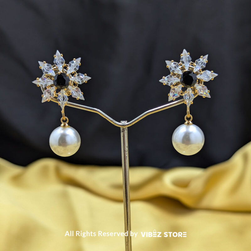 Snowflake Pearl Drop Earrings 3 Snowflake-inspired earrings with a pearl drop, featuring sparkling crystals, ideal for festive and formal wear.