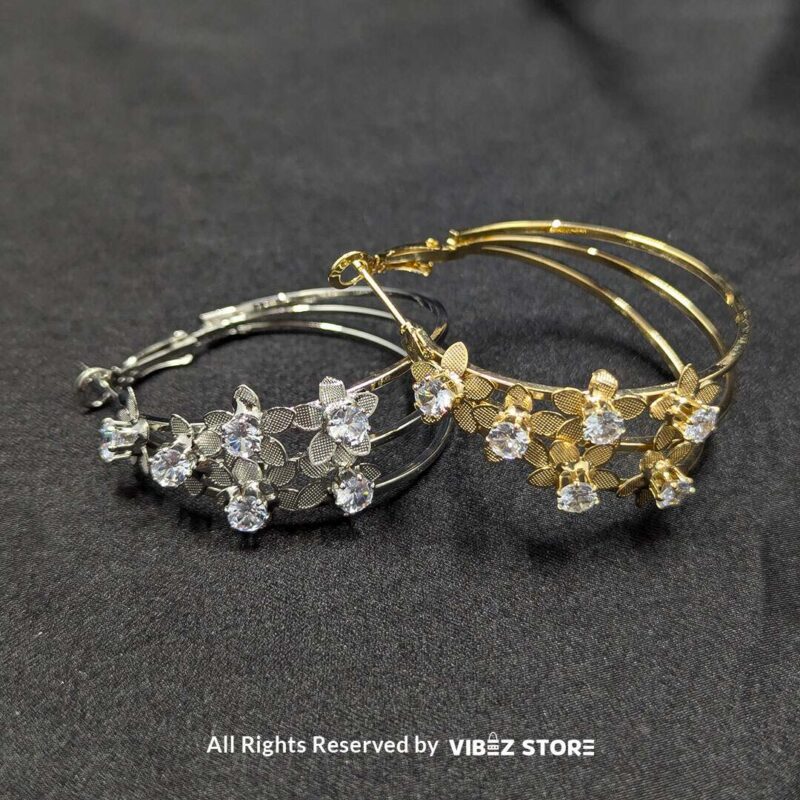 Floral Crystal Hoop Earrings 1 Elegant floral crystal hoop earrings in gold and silver tones with delicate flower accents.