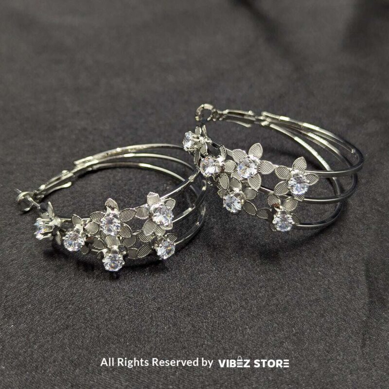 Floral Crystal Hoop Earrings 3 Elegant floral crystal hoop earrings in gold and silver tones with delicate flower accents.