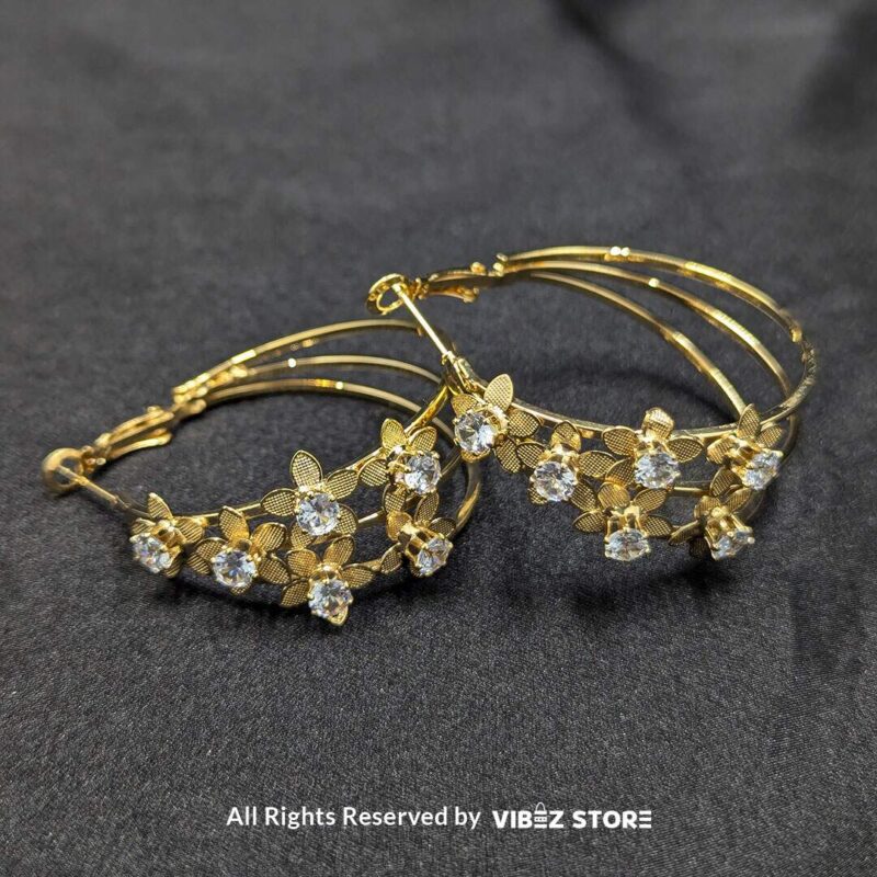 Floral Crystal Hoop Earrings 2 Elegant floral crystal hoop earrings in gold and silver tones with delicate flower accents.