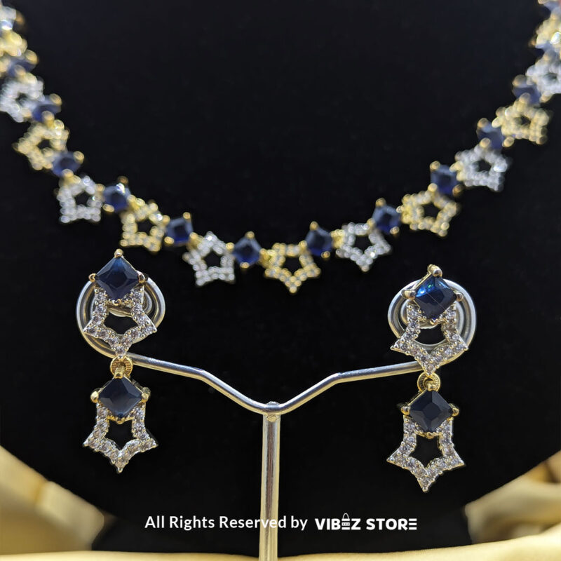 Midnight Sapphire Star Necklace 5 Midnight Sapphire Star Necklace and Earring Set with gold-tone star designs, faux sapphire stones, and crystal accents from VibezStore