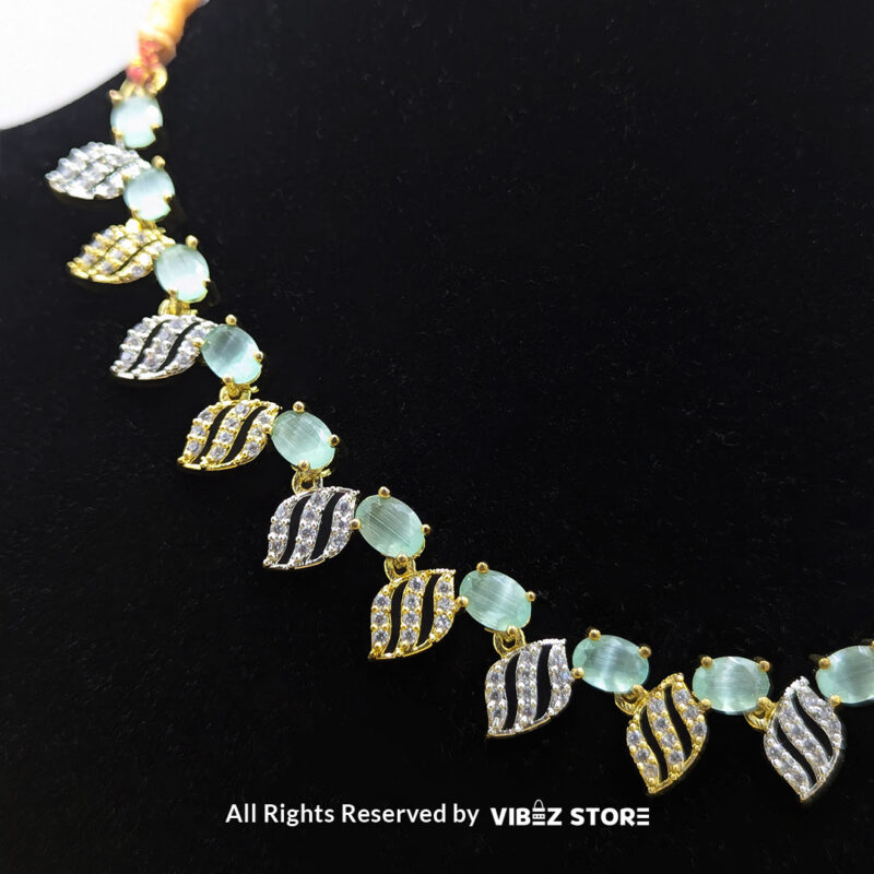 Mint Green Leaf Necklace & Earring Set Gold-Tone Crystal Jewelry 4 Mint Green Leaf Necklace and Earring Set with gold-tone settings, mint green gemstones, and leaf-shaped crystal designs from VibezStore