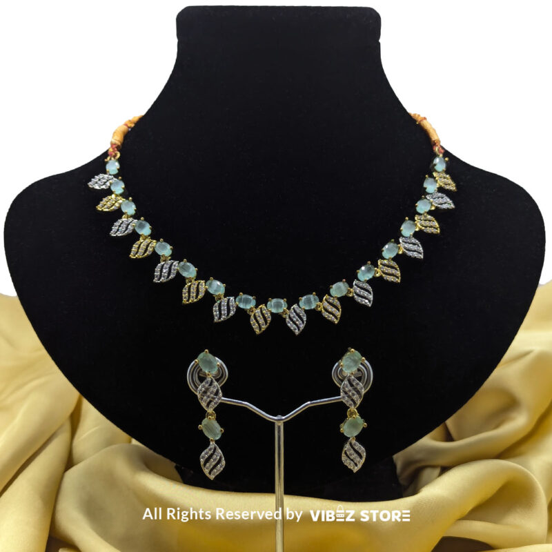 Mint Green Leaf Necklace & Earring Set Gold-Tone Crystal Jewelry 1 Mint Green Leaf Necklace and Earring Set with gold-tone settings, mint green gemstones, and leaf-shaped crystal designs from VibezStore
