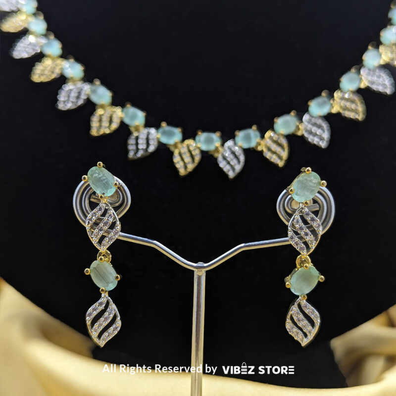 Mint Green Leaf Necklace & Earring Set Gold-Tone Crystal Jewelry 5 Mint Green Leaf Necklace and Earring Set with gold-tone settings, mint green gemstones, and leaf-shaped crystal designs from VibezStore